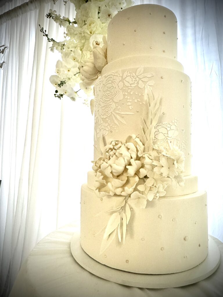 White wedding cake with white gumpaste peony