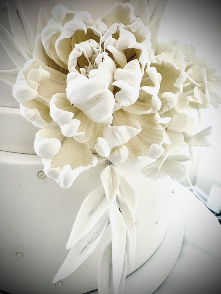 White wedding cake with white gumpaste peony