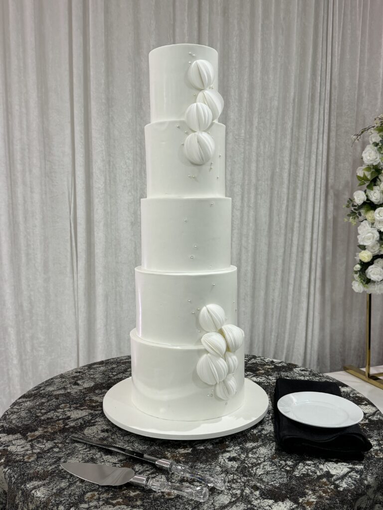 white wedding cake with wafer paper spheres